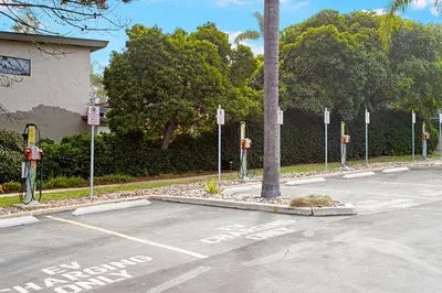 a parking lot with parking meters and a palm tree at Villa del Pacifico - SONG20 in Solana Beach
