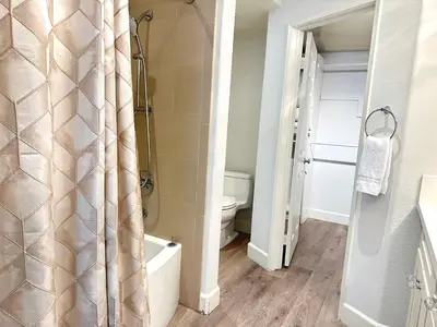a bathroom with a shower curtain and a toilet at Close to Irvine IVC&UCI gate community2b &3b house more than 30nights in Irvine