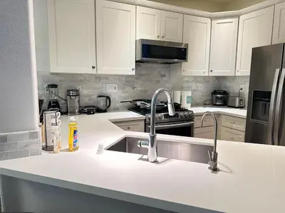 a kitchen with white cabinets and a sink at Close to Irvine IVC&UCI gate community2b &3b house more than 30nights in Irvine