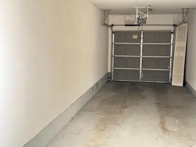 an empty room with a garage door and a concrete floor at Close to Irvine IVC&UCI gate community2b &3b house more than 30nights in Irvine