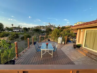 a wooden deck with a table and chairs on it at Serenity - Amazing Views & Modern Charm in La Mesa