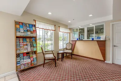 a waiting room with a table and chairs and a counter at Hotel Avenida, San Clemente Beach in San Clemente