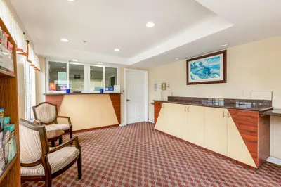 a waiting room with a counter and chairs at Hotel Avenida, San Clemente Beach in San Clemente