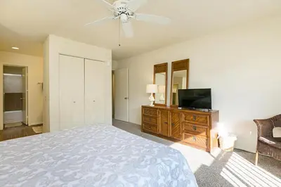 a bedroom with a bed and a flat screen tv at Beachy Keen & Cleen - DMBC148S in Solana Beach