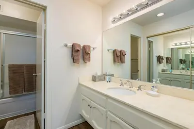 a bathroom with a sink and a mirror at Beachy Keen & Cleen - DMBC148S in Solana Beach