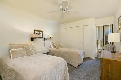 a bedroom with two beds and a ceiling fan at Beachy Keen & Cleen - DMBC148S in Solana Beach