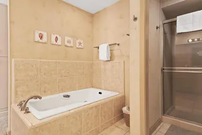 a bathroom with a tub and a shower at SandyToes-SunKist Nose-CHAT2 in Solana Beach