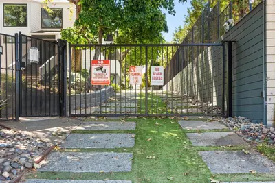 a black fence with signs in front of a house at SandyToes-SunKist Nose-CHAT2 in Solana Beach