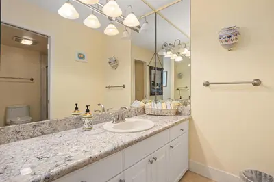 a bathroom with a sink and a large mirror at Dolphin View - SUR43 in Solana Beach
