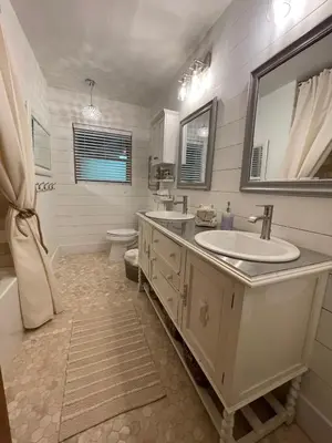 a bathroom with a sink and a toilet and a mirror at Avocado House in El Cajon