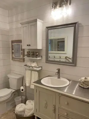 a bathroom with a sink and a toilet and a mirror at Avocado House in El Cajon