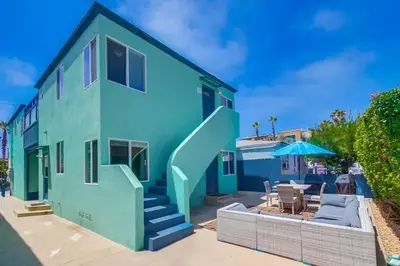 a blue house with a staircase and a patio at Manhattan Shores 1A in San Diego