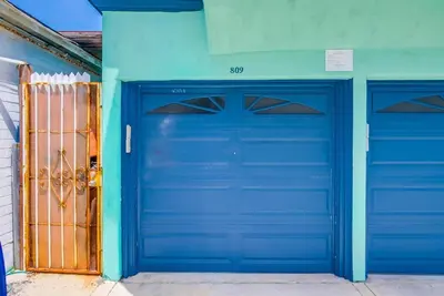 two blue garage doors on a blue building at Manhattan Shores 1A in San Diego