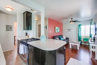 a kitchen and living room with a stove top oven at Manhattan Shores 1A in San Diego
