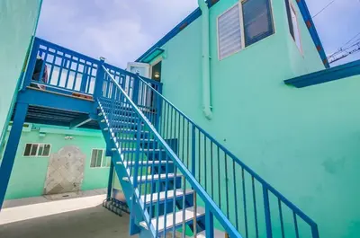 a blue building with stairs leading up to it at Manhattan Shores 1A in San Diego