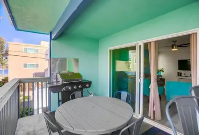 a patio with a table and a grill on a balcony at Manhattan Shores 5 in San Diego