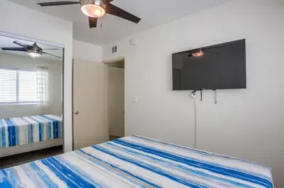 a bedroom with a bed and a flat screen tv at Manhattan Shores 5 in San Diego