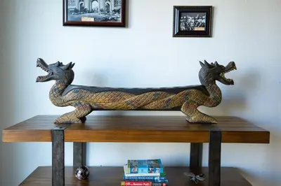a wooden horse statue sitting on top of a table at Poker and Golf Club, Stream movies & Sports in San Diego