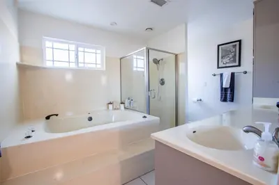 a large white bathroom with a tub and a sink at Poker and Golf Club, Stream movies & Sports in San Diego