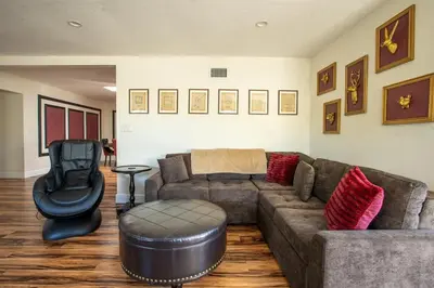 a living room with a couch and a chair at Poker and Golf Club, Stream movies & Sports in San Diego