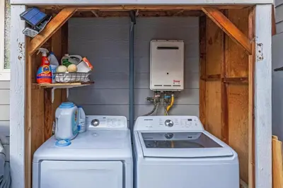 a kitchen with a stove and a washing machine at Cozy Coastal Escape Beach & Brews in San Diego