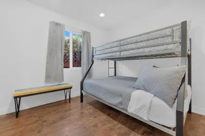 a bedroom with a bunk bed and a table at Cozy Coastal Escape Beach & Brews in San Diego