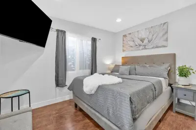 a bedroom with a bed and a television in it at Cozy Coastal Escape Beach & Brews in San Diego