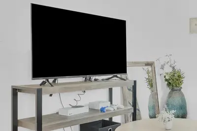 a television on a stand in a living room at Cozy Coastal Escape Beach & Brews in San Diego