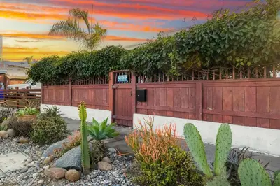 a house with a fence with plants on it at Cozy Coastal Escape Beach & Brews in San Diego