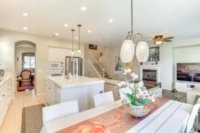 a kitchen and living room with a table and chairs at 14 Mi to Old Town Temecula Luxe Fallbrook Home! in Fallbrook