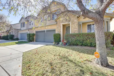 a house with a tree in front of a driveway at 14 Mi to Old Town Temecula Luxe Fallbrook Home! in Fallbrook