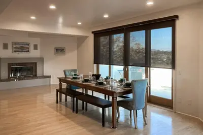 a dining room with a wooden table and chairs at Canyon Paradise in Encinitas