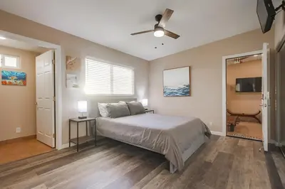 a bedroom with a bed and a ceiling fan at Home to enjoy the beach with ocean view in Oceanside