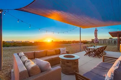 a patio with a couch and a table with a sunset at Home to enjoy the beach with ocean view in Oceanside