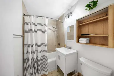 a bathroom with a shower curtain and a sink at Carlsbad Beach Bungalow in Carlsbad