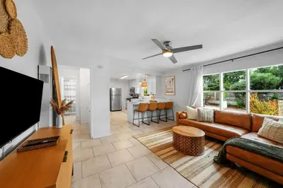 a living room with a couch and a table at Carlsbad Beach Bungalow in Carlsbad