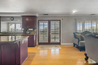 a kitchen with a counter and a living room at Temecula Valley Private Estate Panoramic Mountain & Pool Views in Murrieta