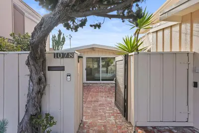 a house with a white gate and a brick driveway at Oceanfront Paradise on Neptune in Encinitas