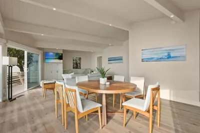 a dining room with a wooden table and chairs at Oceanfront Paradise on Neptune in Encinitas