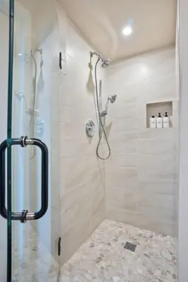 a bathroom with a shower with a glass door at Oceanfront Paradise on Neptune in Encinitas