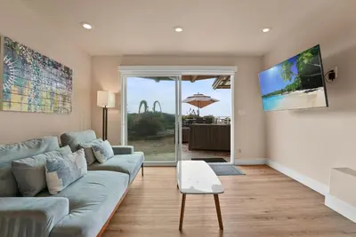 a living room with a couch and a table at Oceanfront Paradise on Neptune in Encinitas