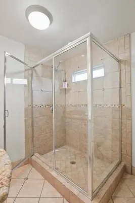 a shower with a glass enclosure in a bathroom at Beachfront Getaway with Ocean Views and Private Patio in Newport Beach