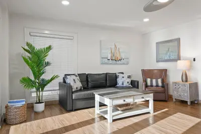 a living room with a couch and a coffee table at Beachfront Getaway with Ocean Views and Private Patio in Newport Beach