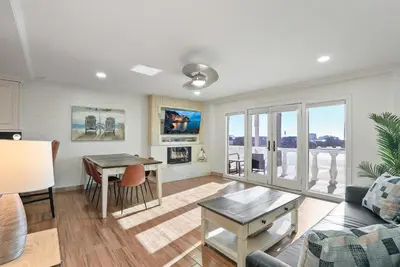 a living room with a couch and a table at Beachfront Getaway with Ocean Views and Private Patio in Newport Beach