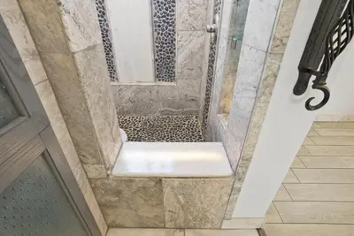 a bathroom with a shower with a glass door at Beachfront Retreat with Ocean Views Private Rooftop Deck Walk to Pier and Town in Newport Beach