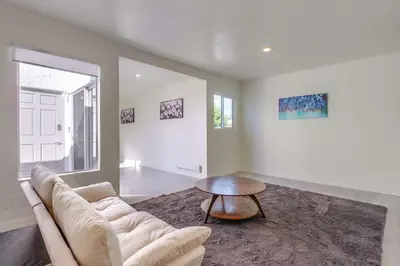 a living room with a couch and a table at 2nd floor A-C steps to beach downtown La Jolla in San Diego