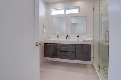 a bathroom with a sink and a mirror at 2nd floor A-C steps to beach downtown La Jolla in San Diego