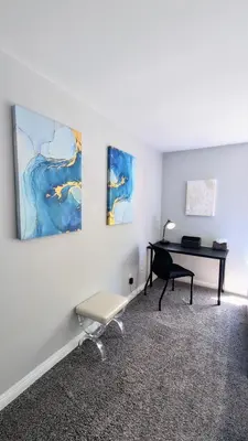 a living room with a piano and a chair at Poolside 2BR Condo with Balcony & Workspace in San Diego