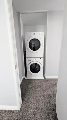 a washer and dryer in a small room at Poolside 2BR Condo with Balcony & Workspace in San Diego