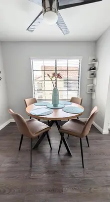 a dining room table with chairs and a vase on it at Poolside 2BR Condo with Balcony & Workspace in San Diego